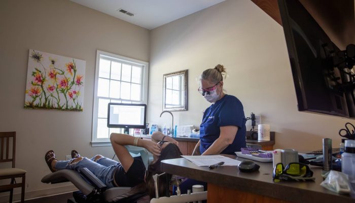 female dentist with patient in dental office in Orange County, VA