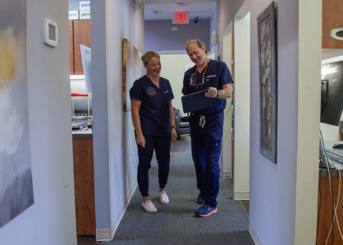 two dentist talking in the hallway